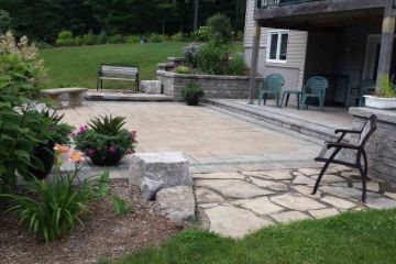 Multi-level patio of pavers with stone accents